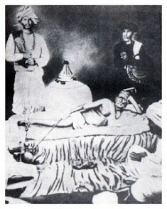 Original photo: Swami Samarth laying on Vyagrarjin (tiger skin); Cholappa Maharaj and another devotee are standing by (1870-1875)